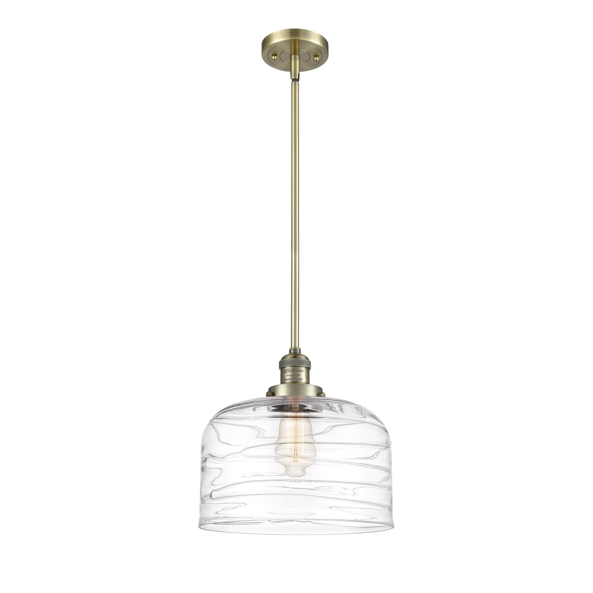 Shown in Antique Brass finish and Clear Deco Swirl X-Large Bell glass