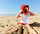 Kid with Red Hat on Beach with Camera